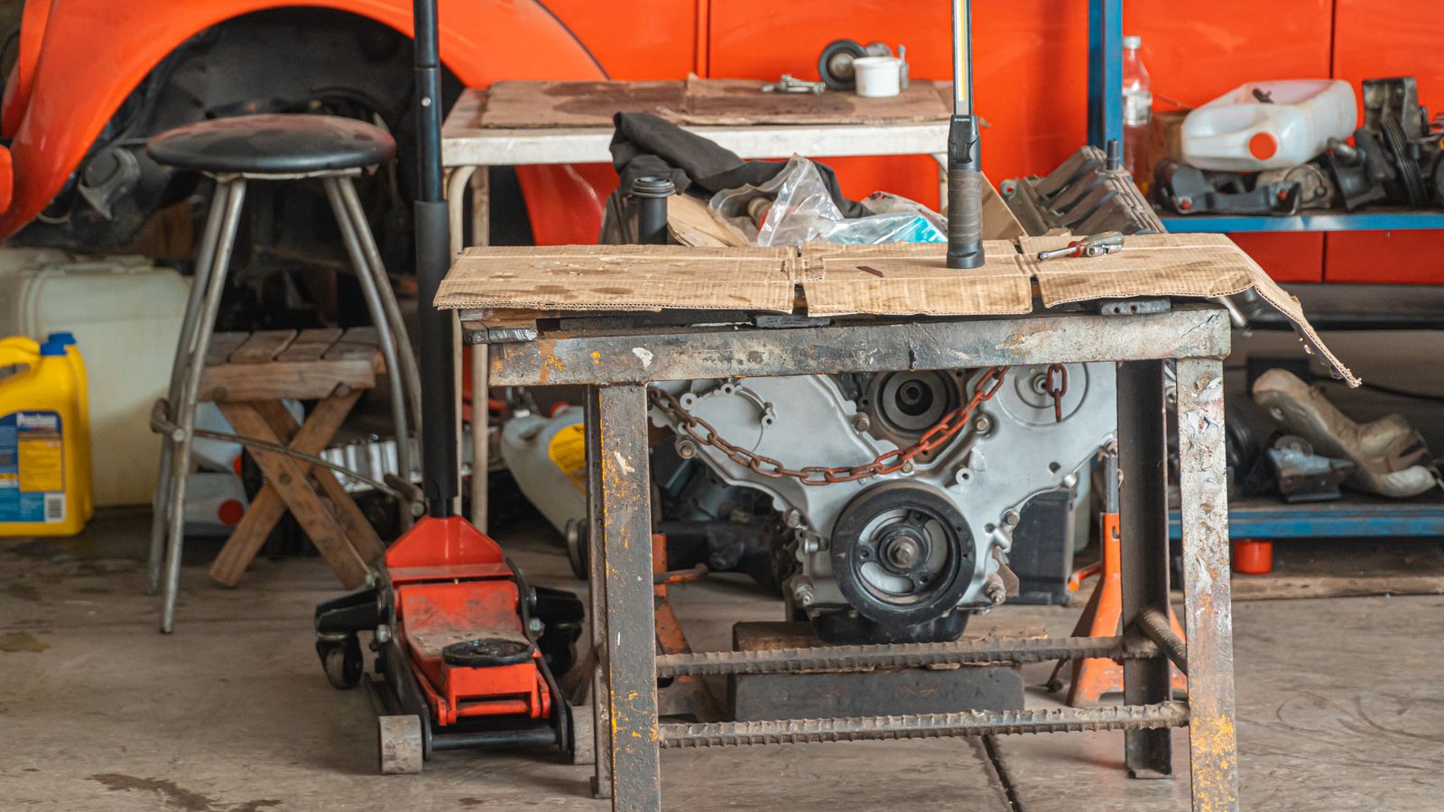 Car engine and maintenance tools on a workshop table