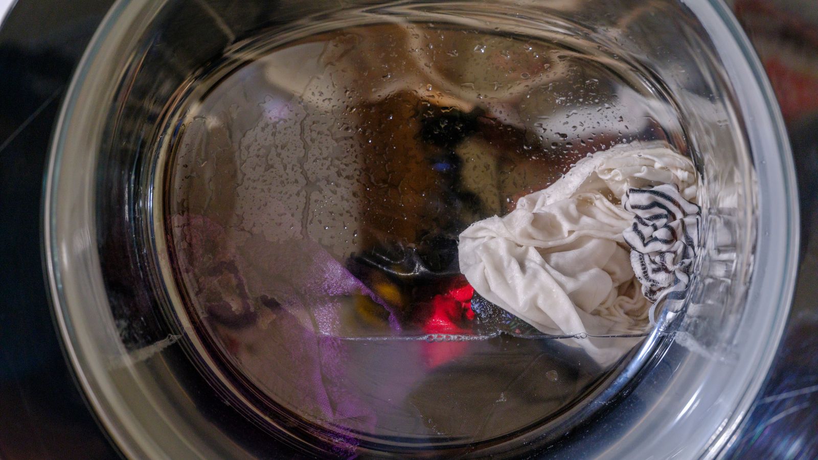 Close-up of a front-loading washing machine drum in motion