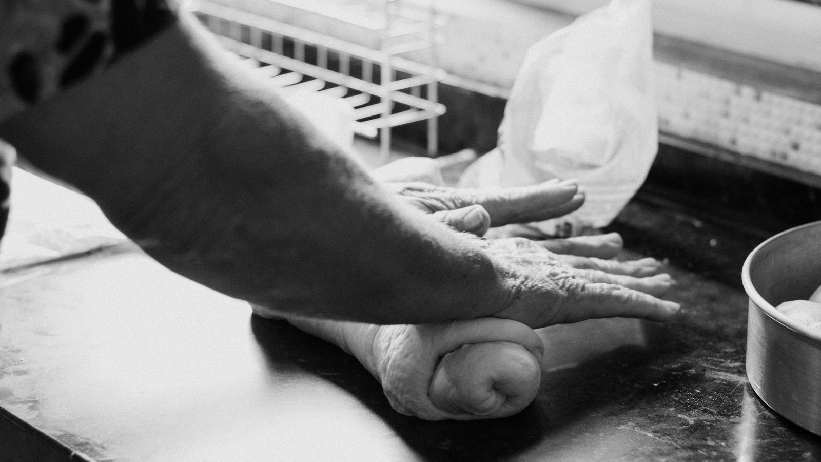 Hands working carefully at a kitchen preparation counter