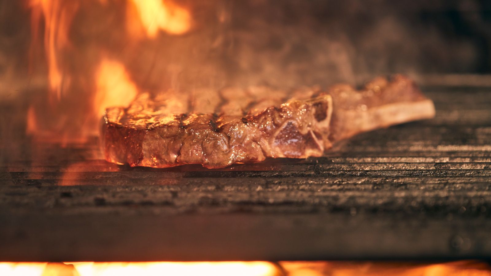 Ribeye steak meeting intense open-flame grill heat