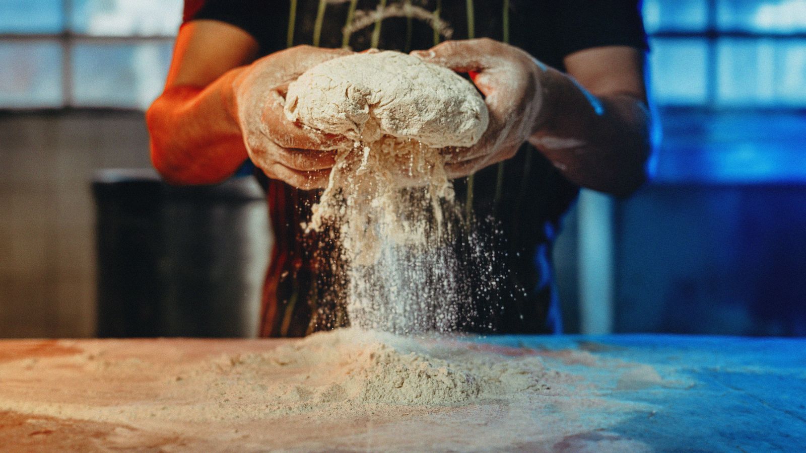 Baker preparing ingredients by hand in a working kitchen