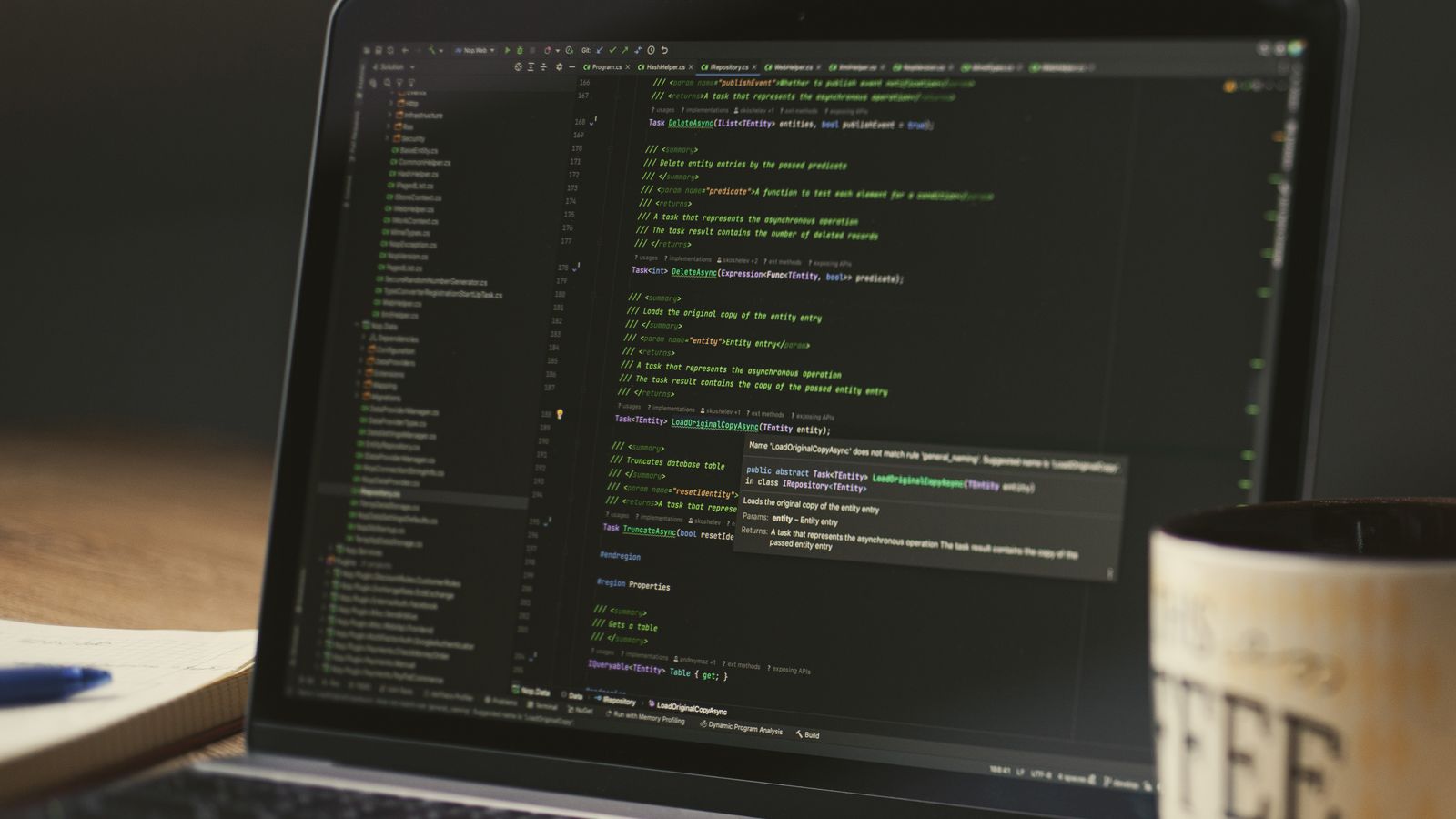 Laptop command line open beside a coffee mug