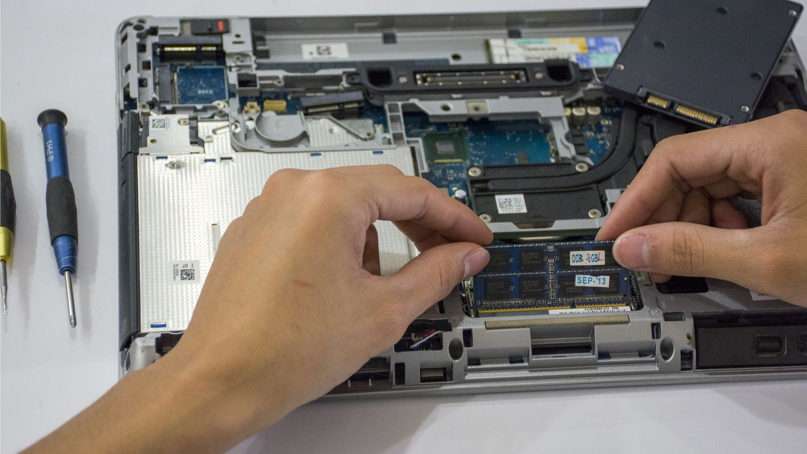 Technician working with internal laptop components