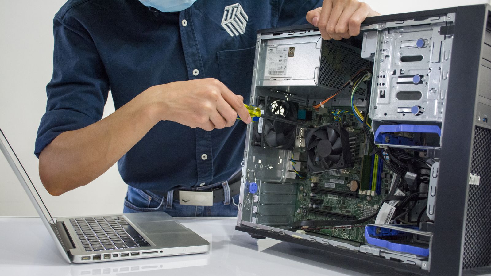 Technician diagnosing a desktop computer