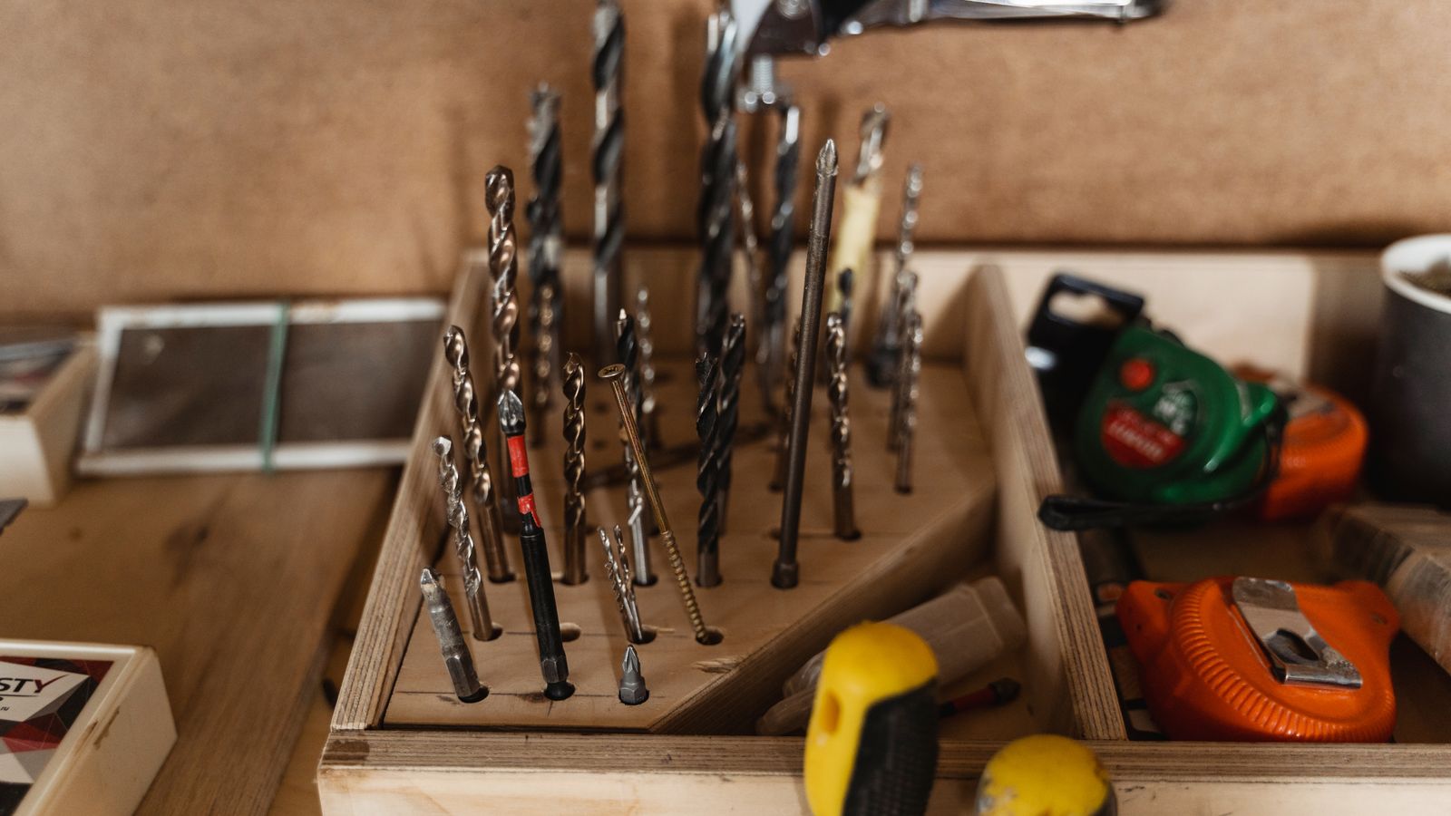 Close-up assortment of drill bits in a workshop organizer