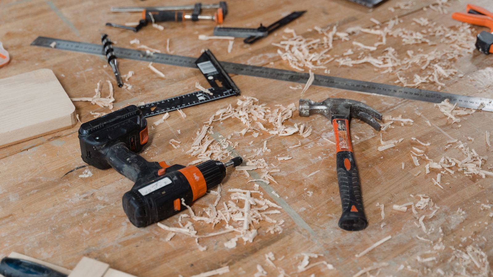 Hand tools arranged on a sawdust-covered work surface